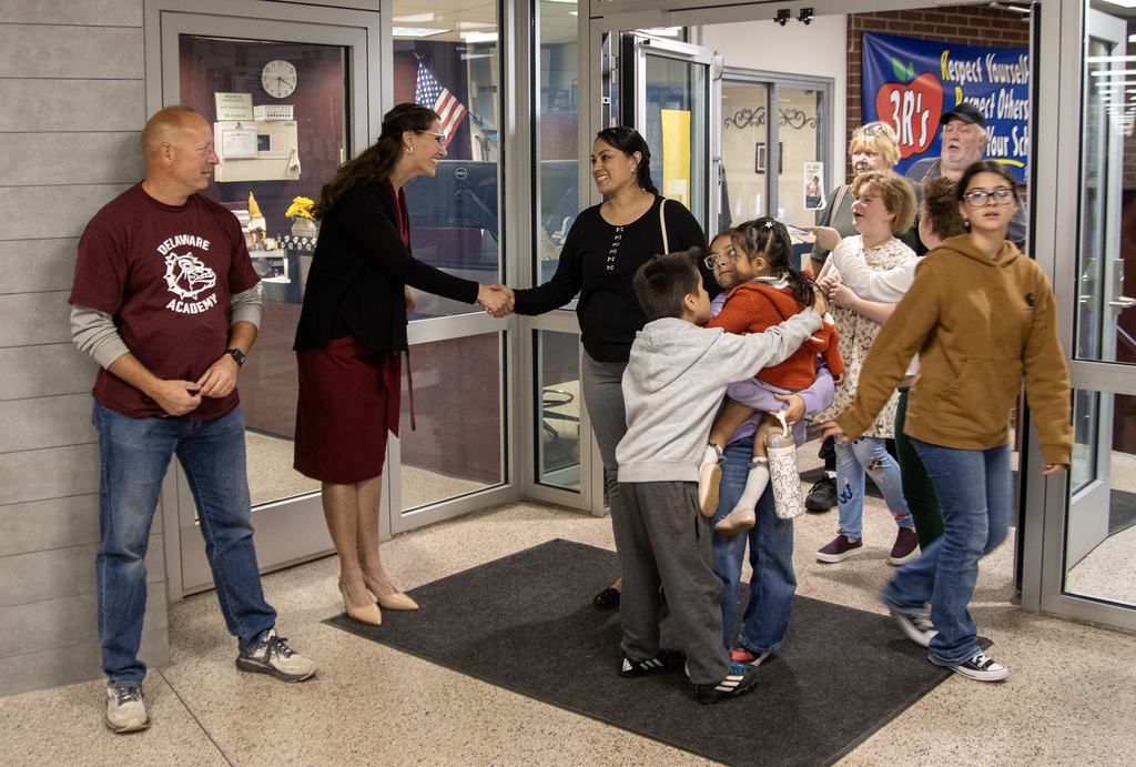 principal meets family at door, SRO watches