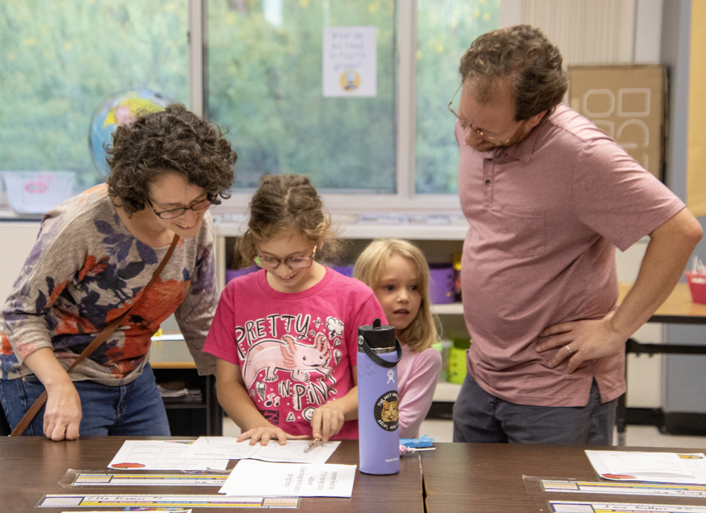 family looking at work