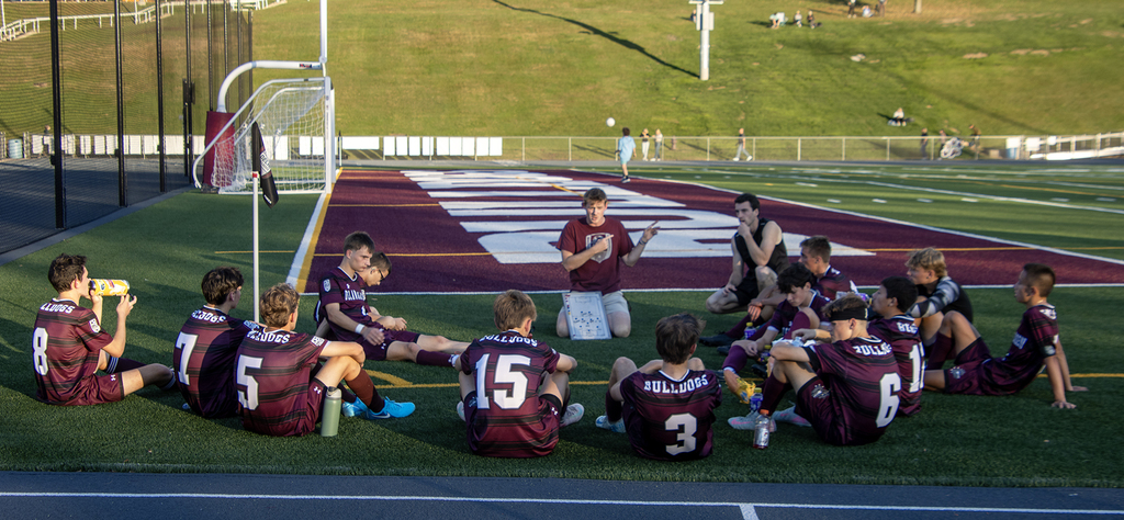 coach speaks to players in circle