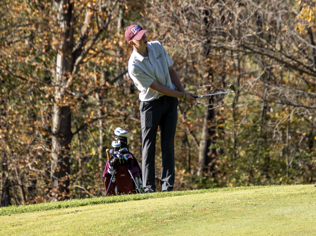 golfer swings from the fairway