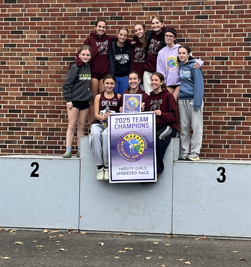 varsity xc team on podium with 1st prize