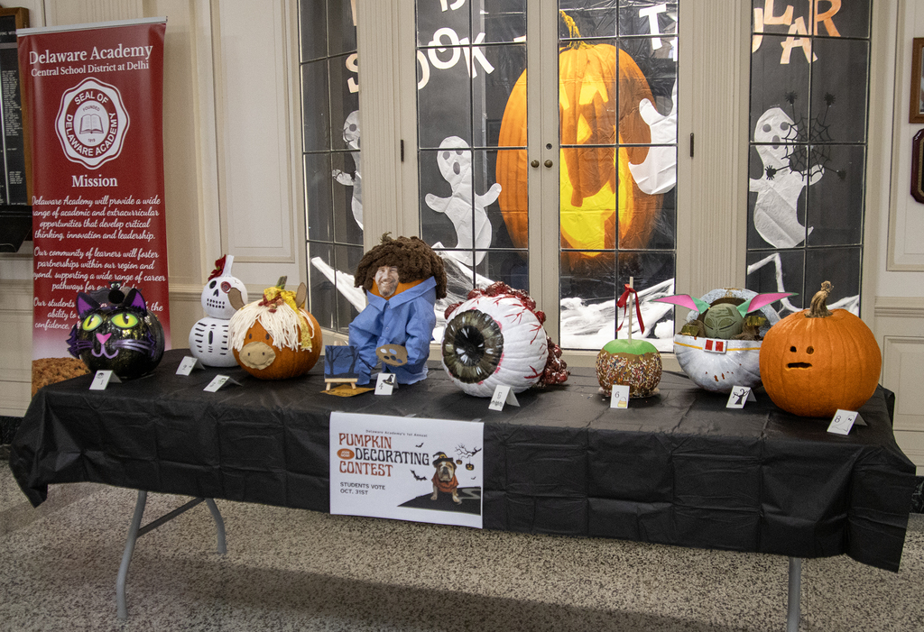 8 decorated pumpkins on display