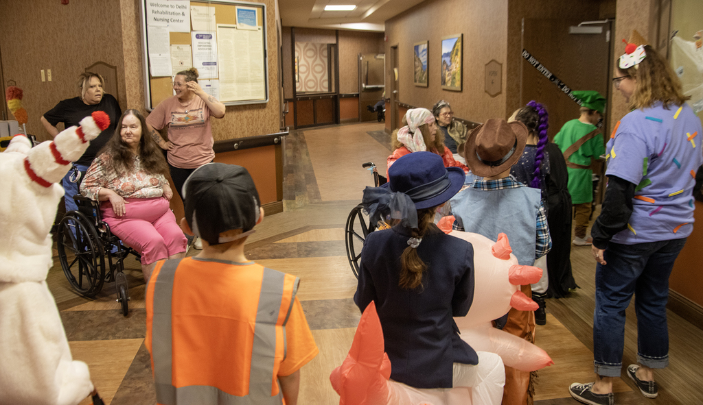 2nd grade students in costume visit with residents of nursing home