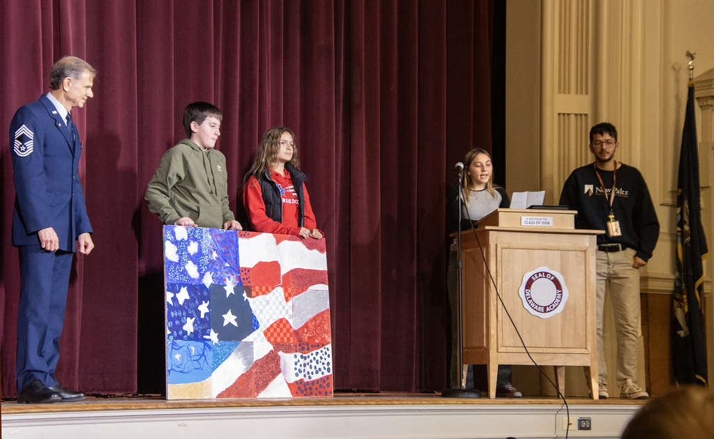 3 students, a teacher and Mr. Wetmore on stage
