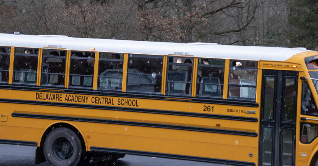 XC team on the bus, waving