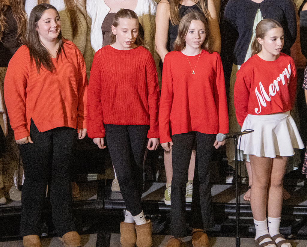 4 girls dressed in red singing