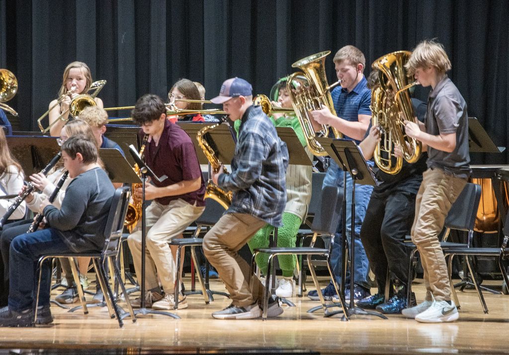 middle school musicians play on stage, standing