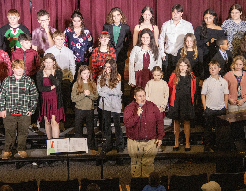 chorus director speaking in front of chorus