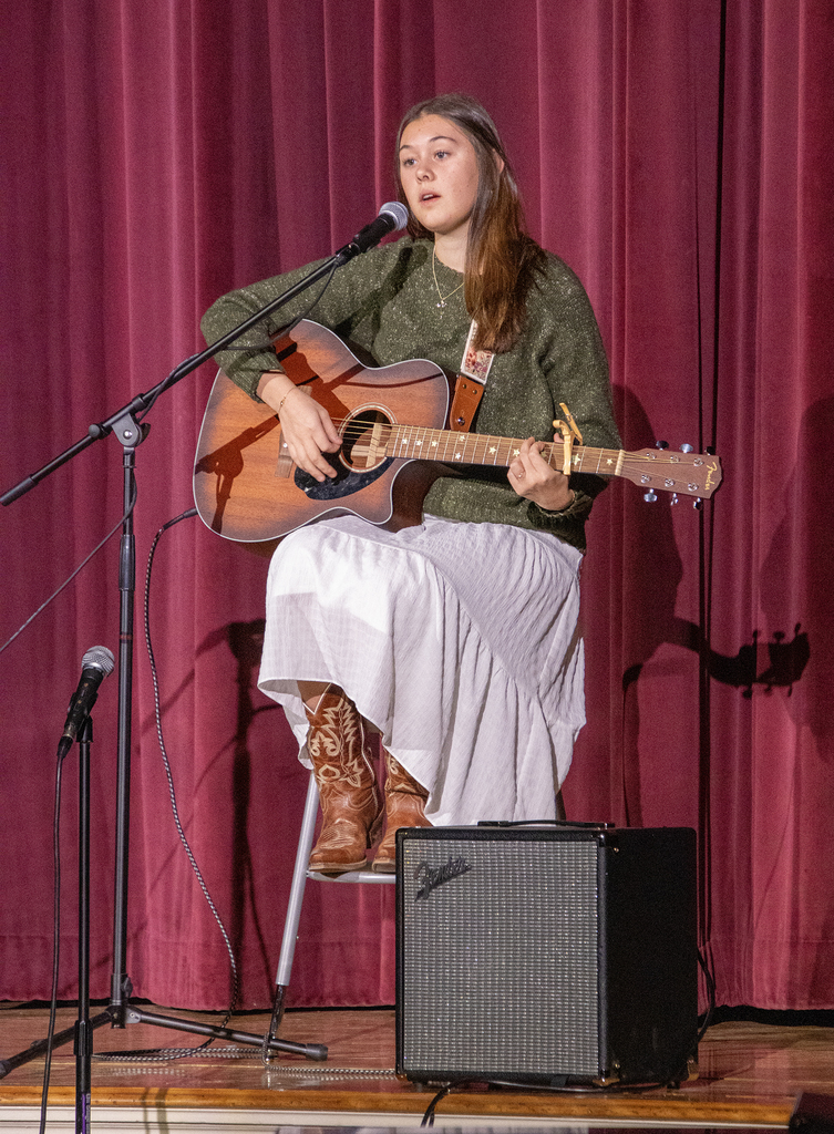 Paisley Smith sings and plays guitar on stage