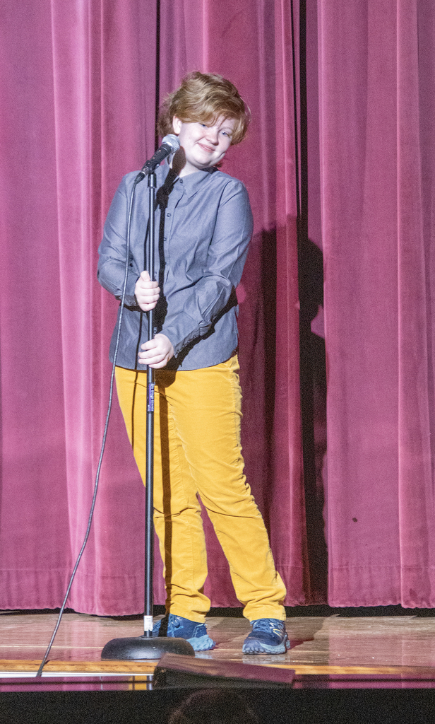 Keiran Synan smiles on stage