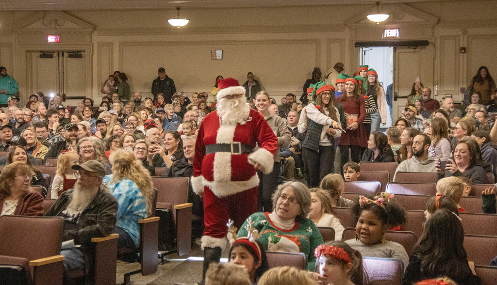 Santa and elves arrive in auditorium