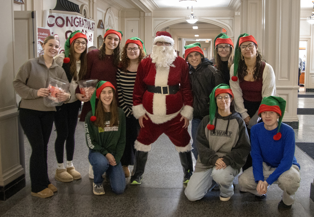 Santa poses with 10 elves (Honor Society members)
