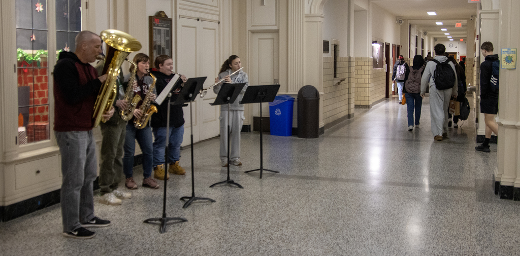 wind ensemble plays Christmas carols in lobby for arriving students