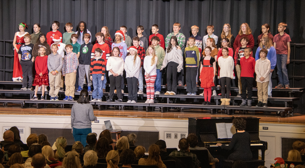 students on risers on stage