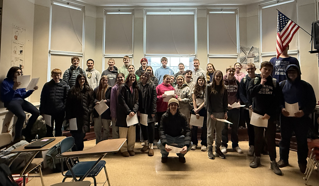 German students pose in classroom