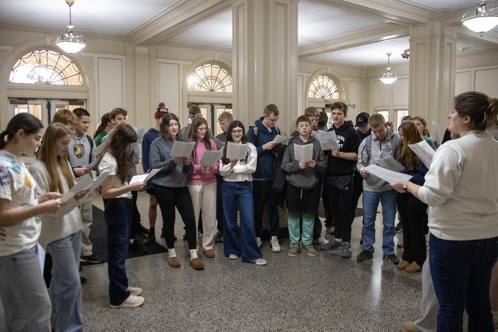 German students singing in the high school lobby