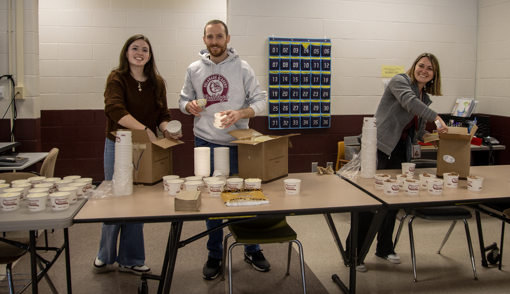 Ms. VanKingsley, Mr. Chaswe and Ms. Trask scooping ice cream and smiling