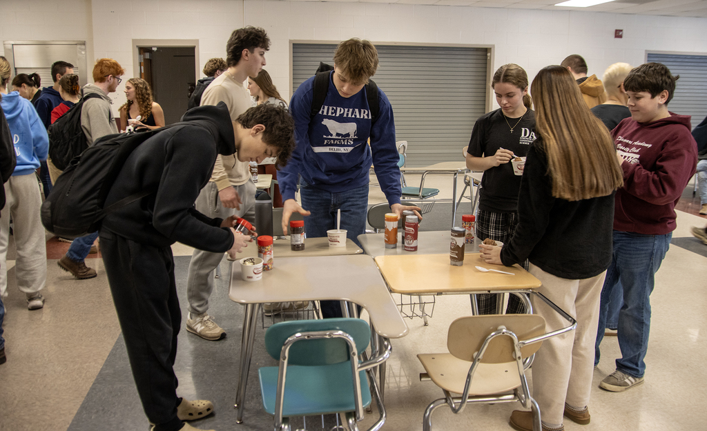 students add toppings to their ice cream