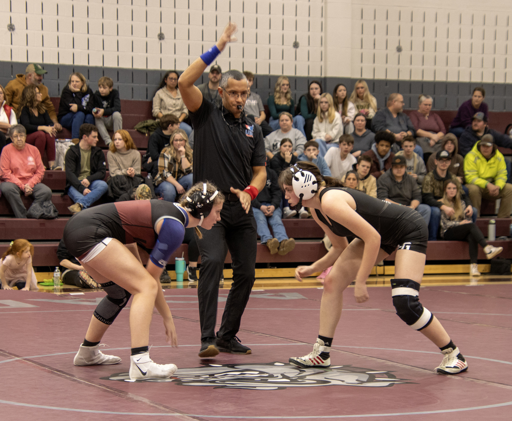 two girls wrestling, official signaling