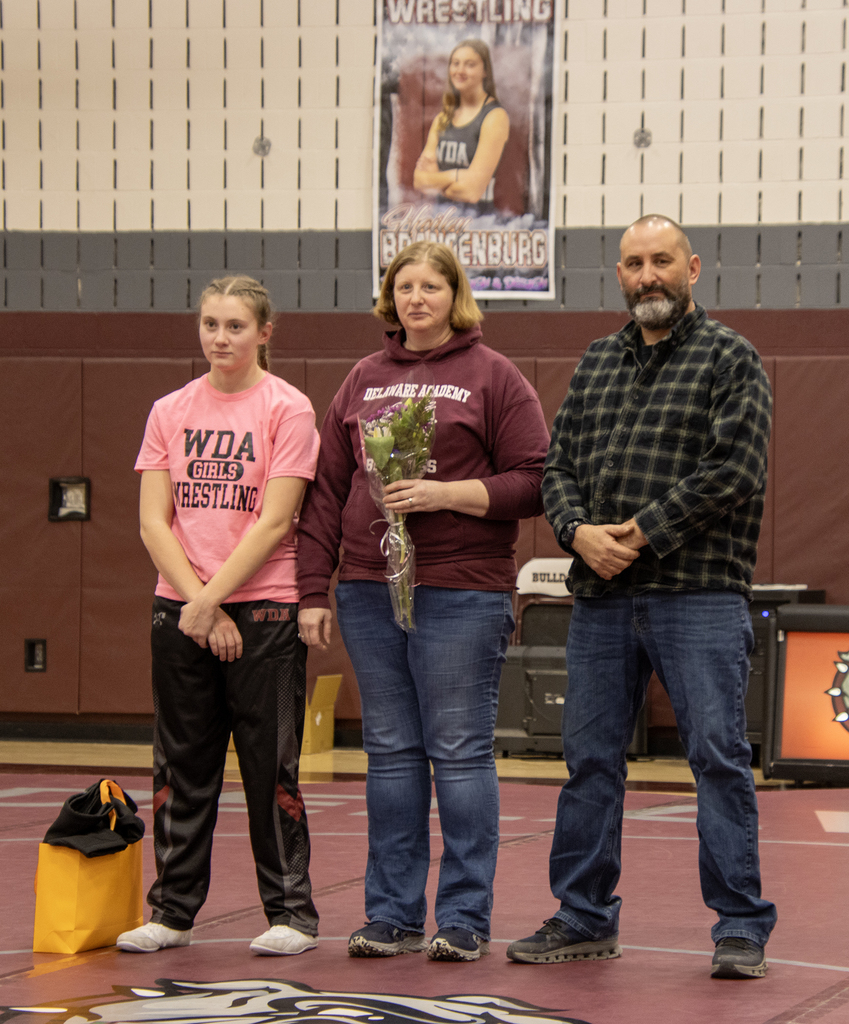 Senior Hailey Brandenburg poses with her parents