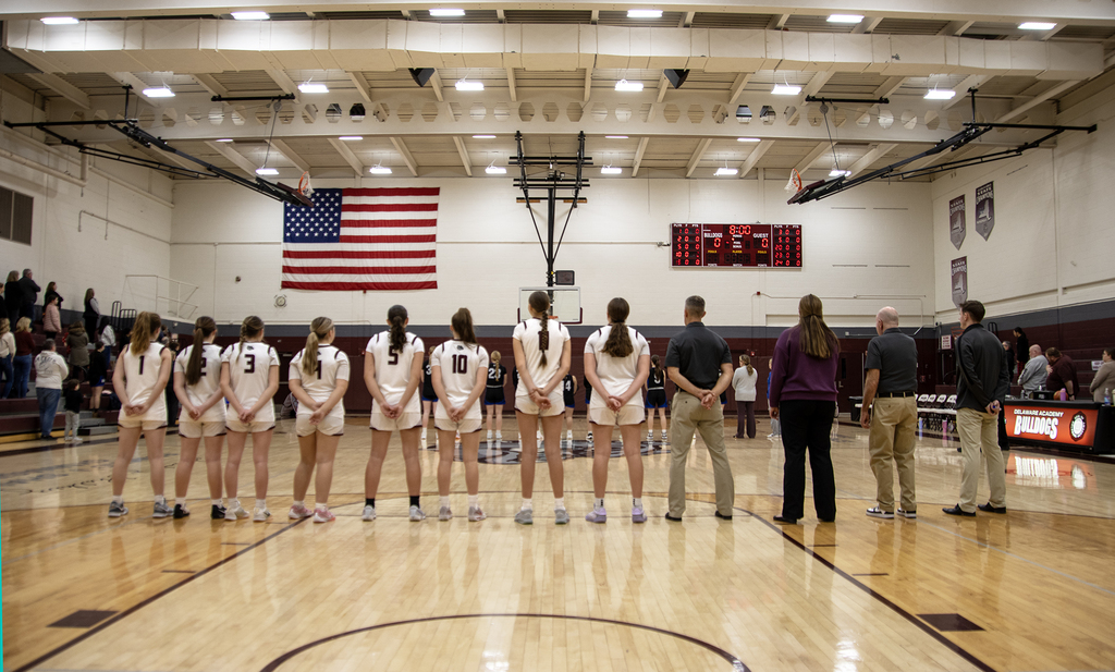 basketball team stand in line for national anthem (viewed from back)
