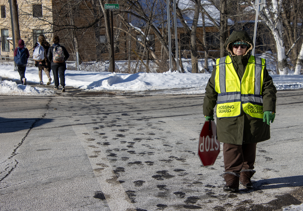Mrs. hood holding stop sign