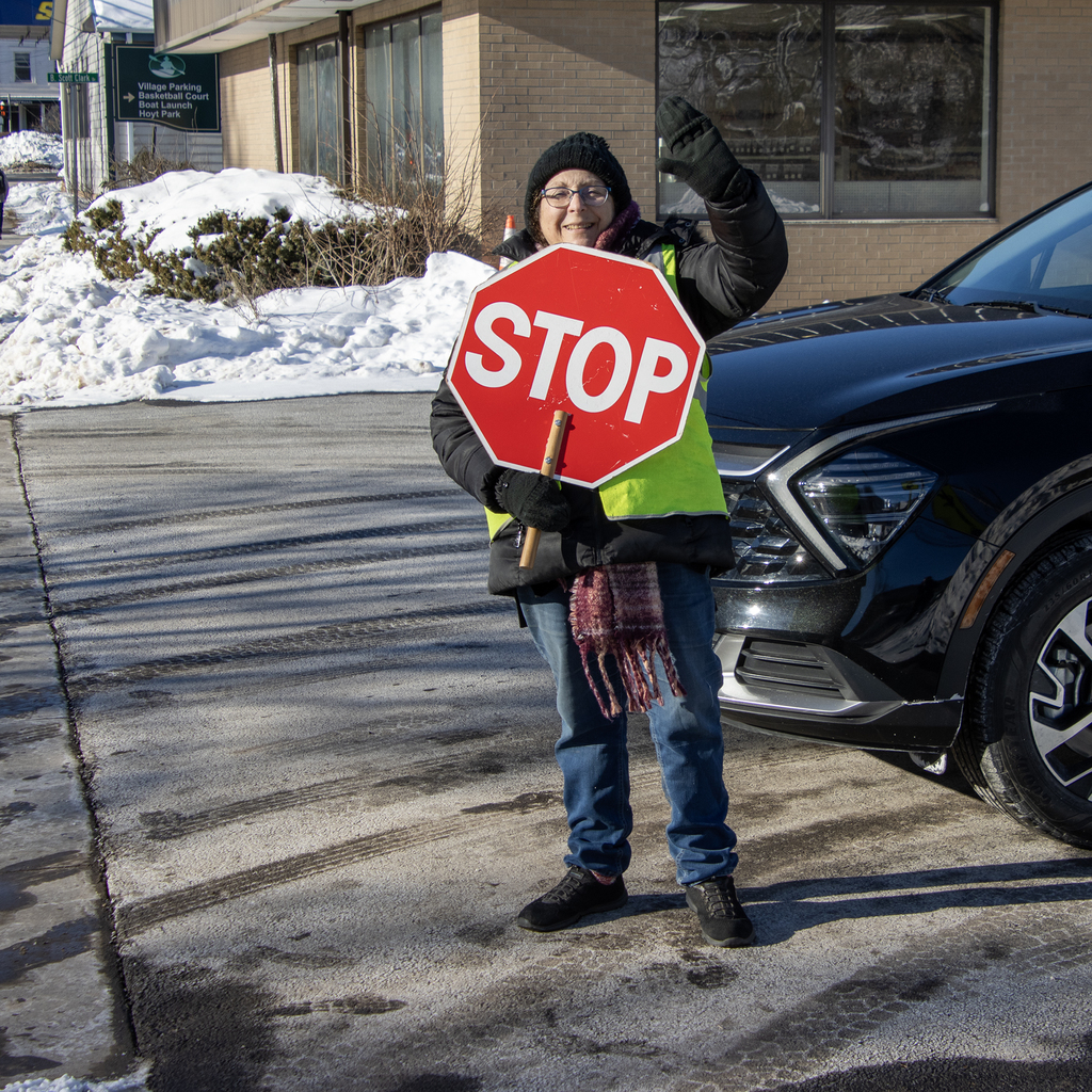 Mrs. Staples  holding stop sign