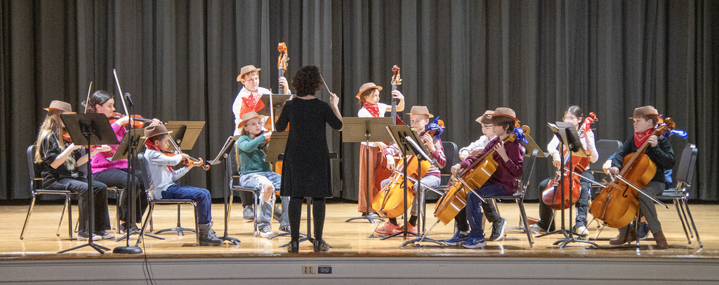 Mrs. Gibson conducts the orchestra