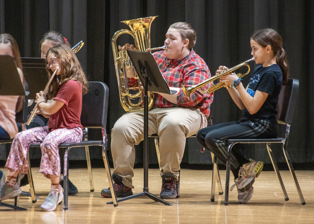 Miss Lamb and 2 students palying instruments