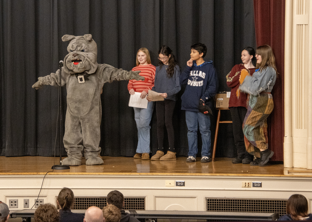 the DA Bulldog mascot on stage with student senate members