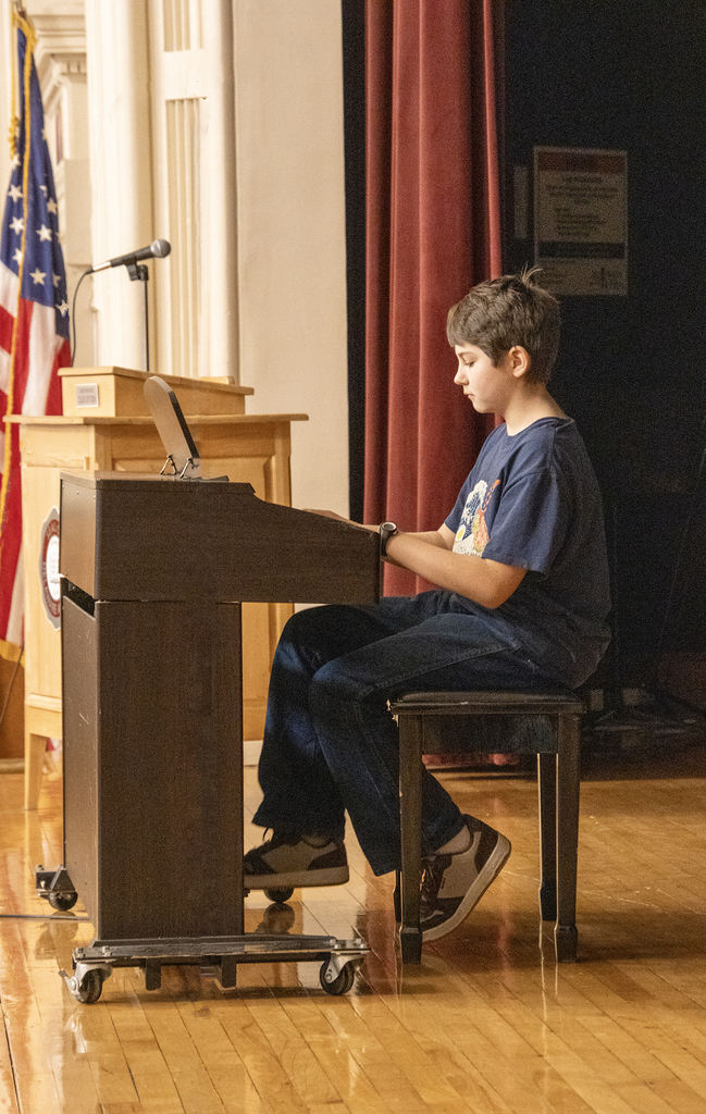 student plays a difficult piano piece