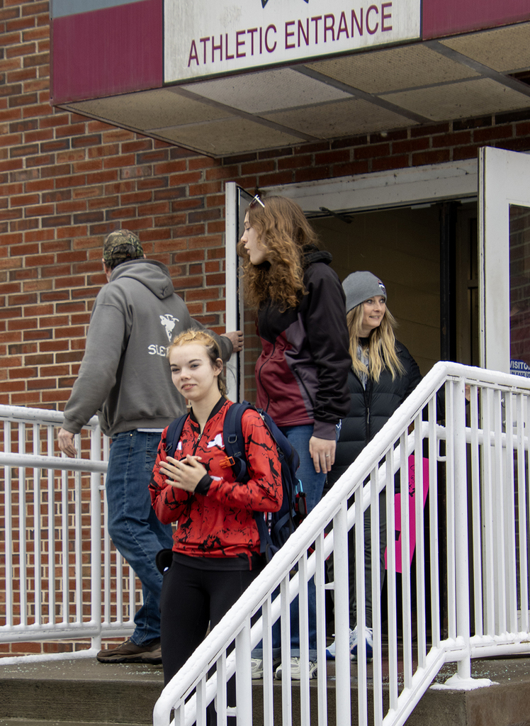 Cadence and coach leave the building through the Athletic Entrance