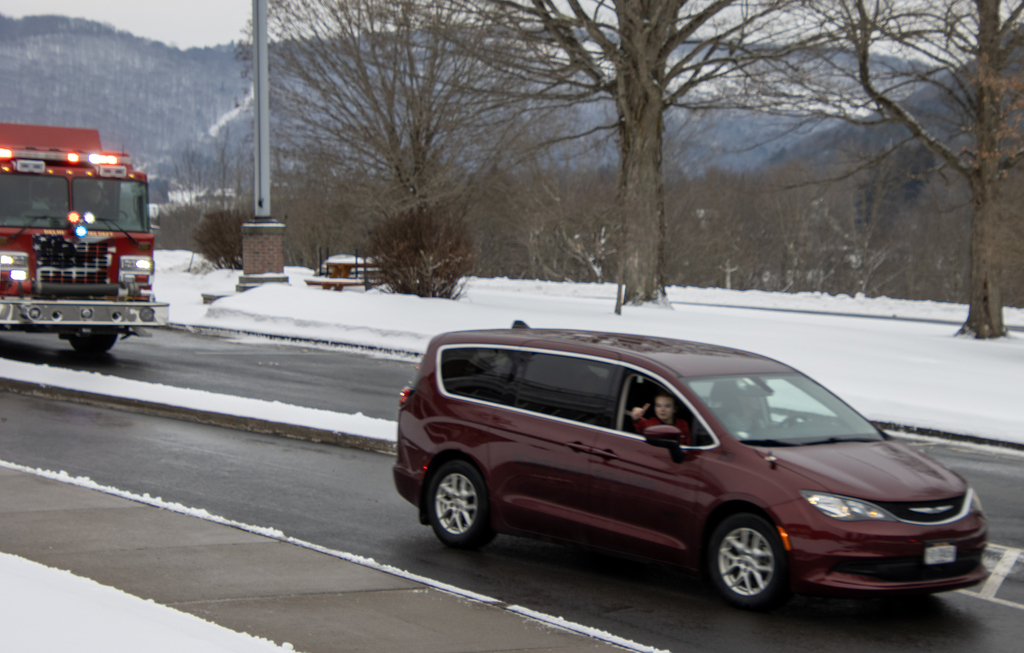 Cadence gives a thumbs up from car; fire truck follows