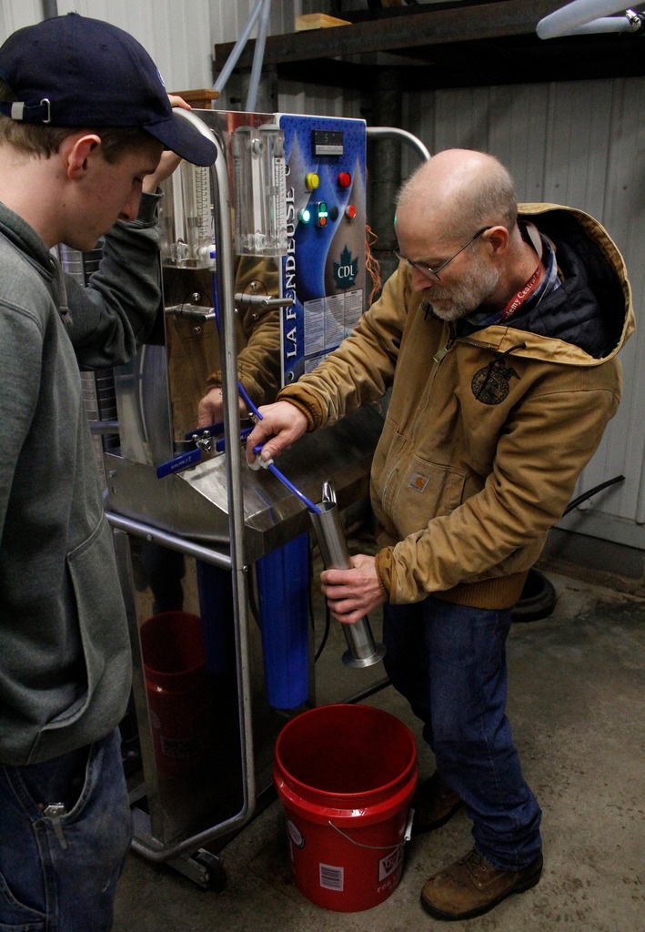 student and Mr. Kline in maple shack