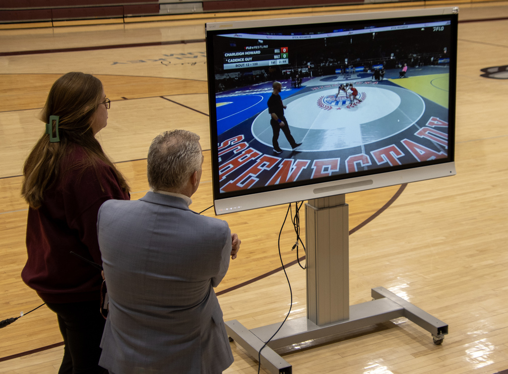 PE teacher and Superintendent watching Cadence on the screen