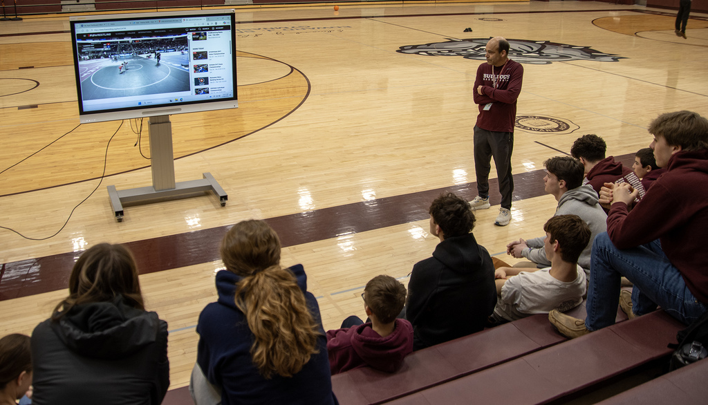 PE teacher and students watching Cadence on the screen