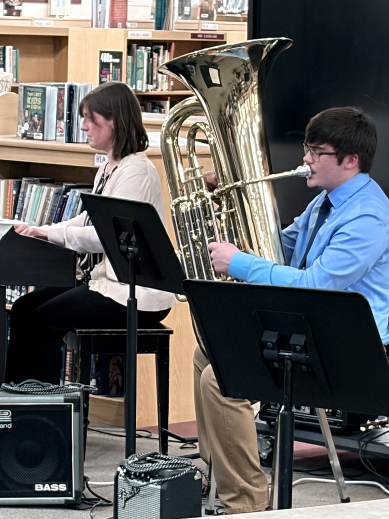 music teacher and student playing tuba