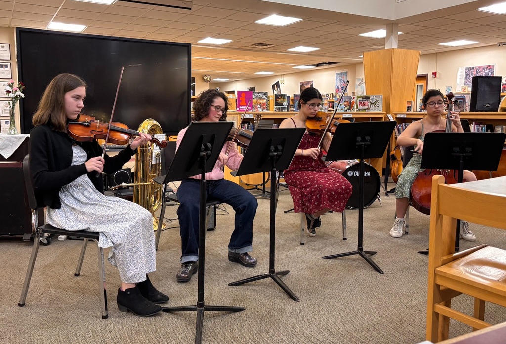 3 students and a teacher in a string ensemble