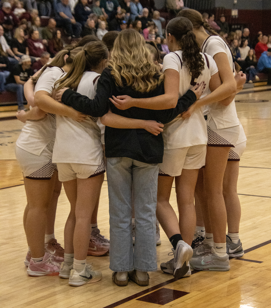 girls team huddles on court