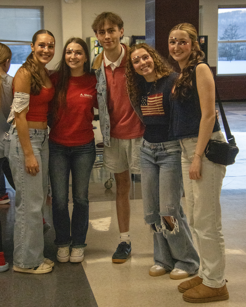 4 girls and a guy pose for pictures