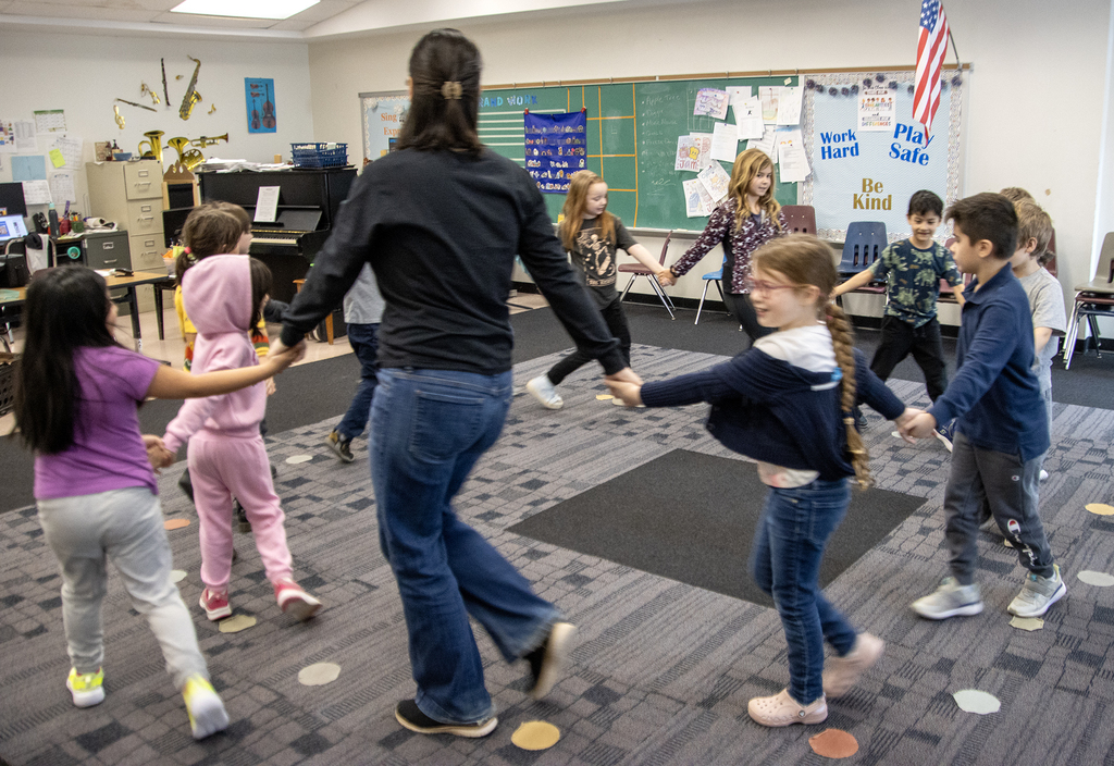 1st grade students dancing with music teacher