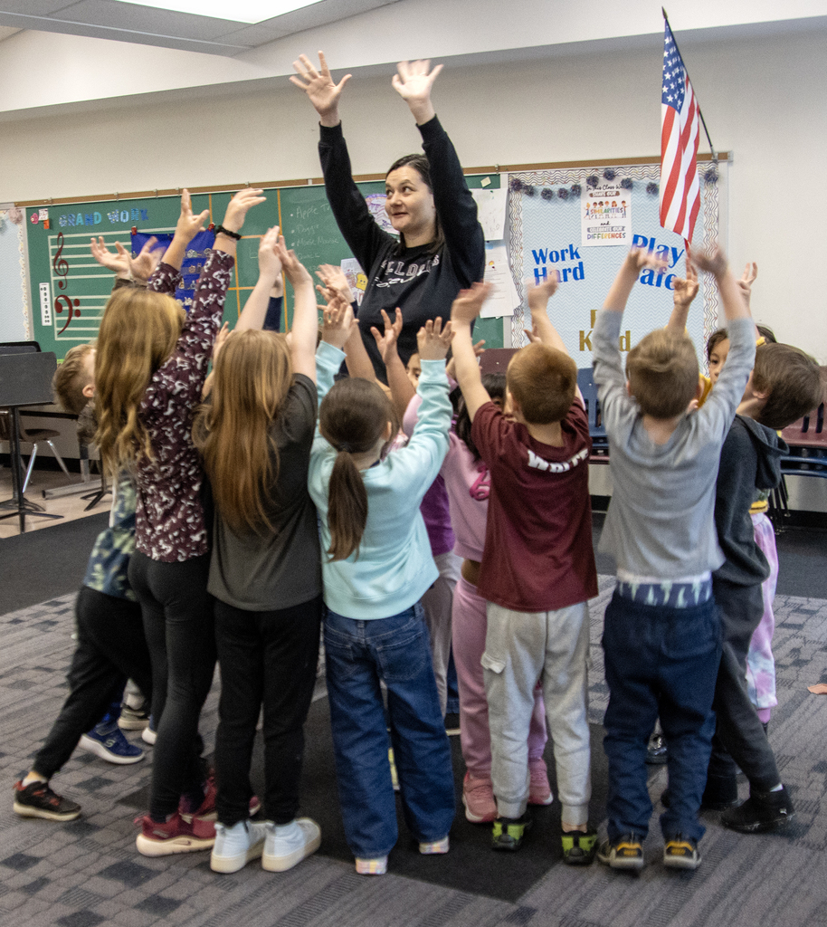 1st grade students dancing with music teacher