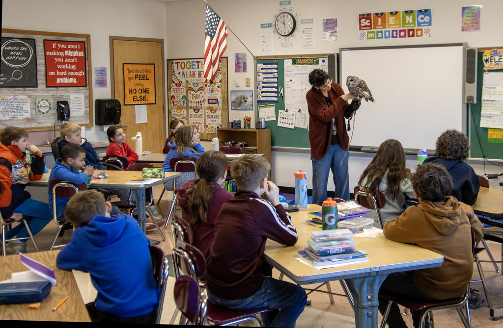 Mellow the owl and Genevieve Salerno visiting a classroom