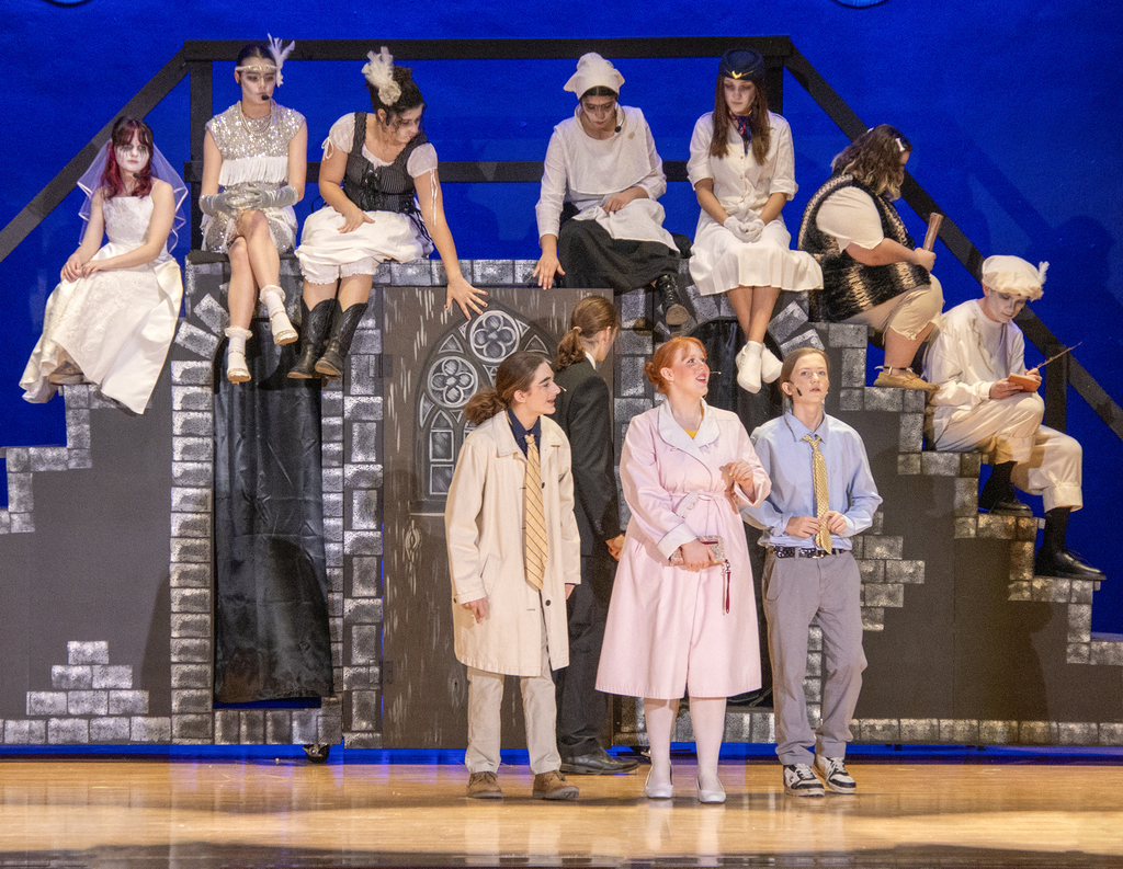 11 students cast members on stage