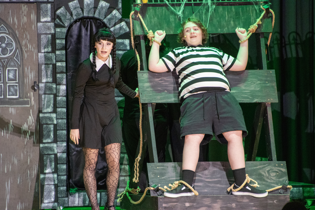 Wednesday torturing Pugsley on stage