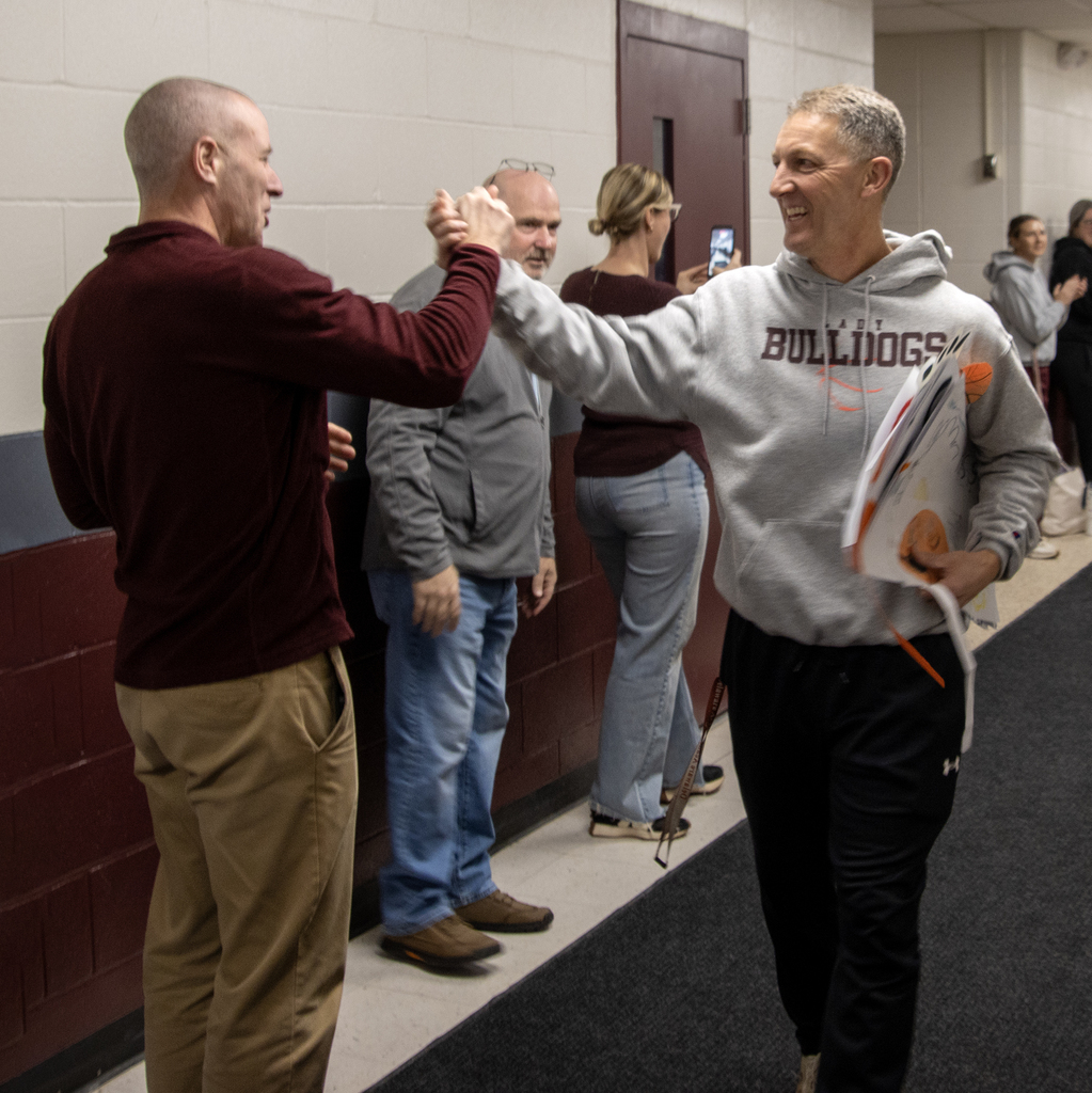 Coach Baxter offers a hand to Coach Bruce
