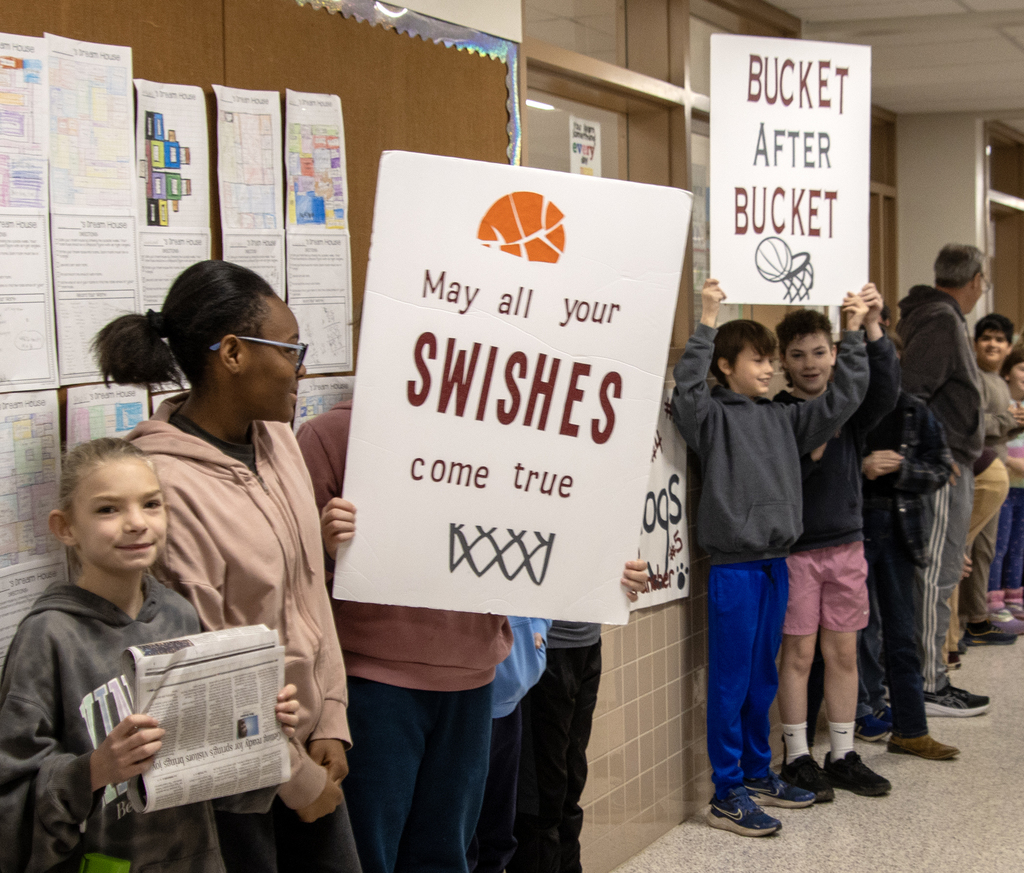 students holding signs: May all your swishes come true and Bucket after Bucket