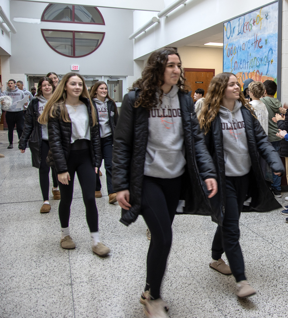 team is applauded in the middle school lobby