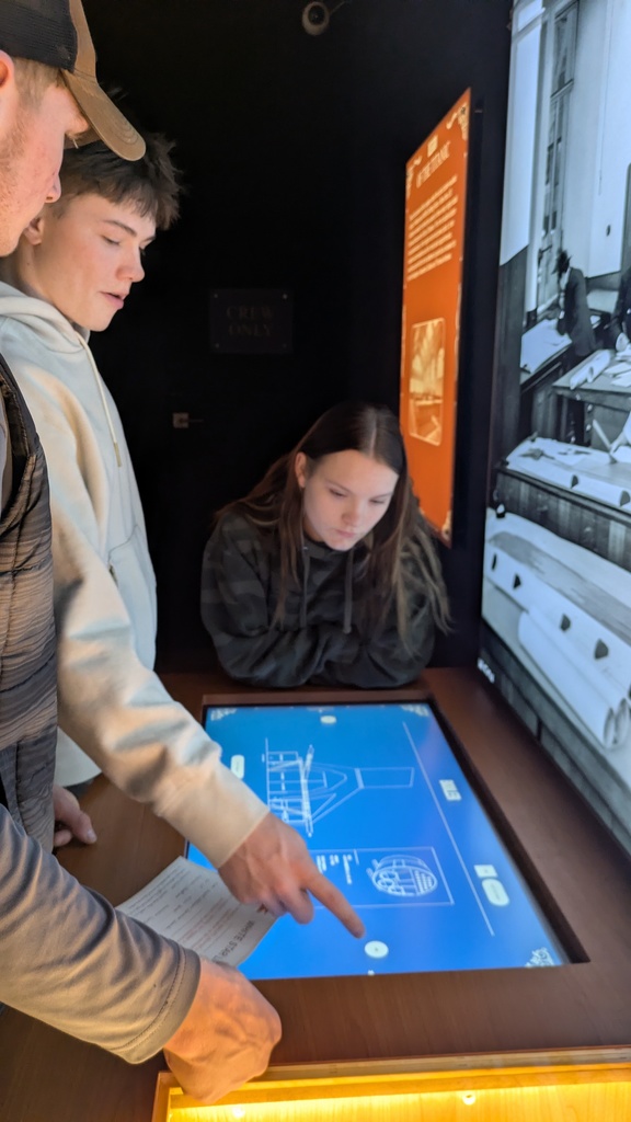 students look at an interactive digital screen