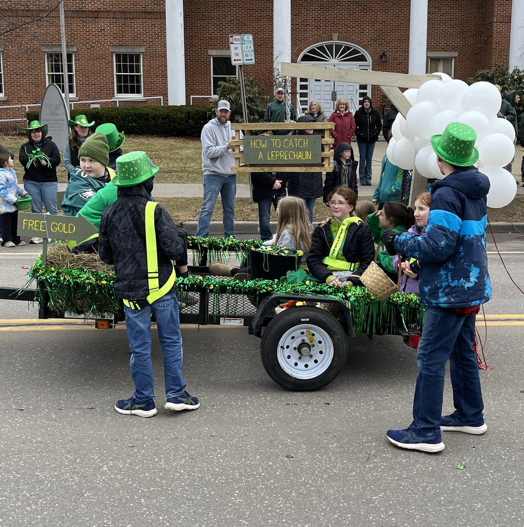 9 students on a leprechaun float